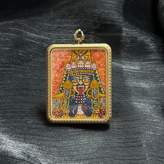 Front view of Zaki Ram mini thangka pendant featuring hand-painted Nepalese thangka art with vibrant mineral pigments inside a gold-tone pendant frame