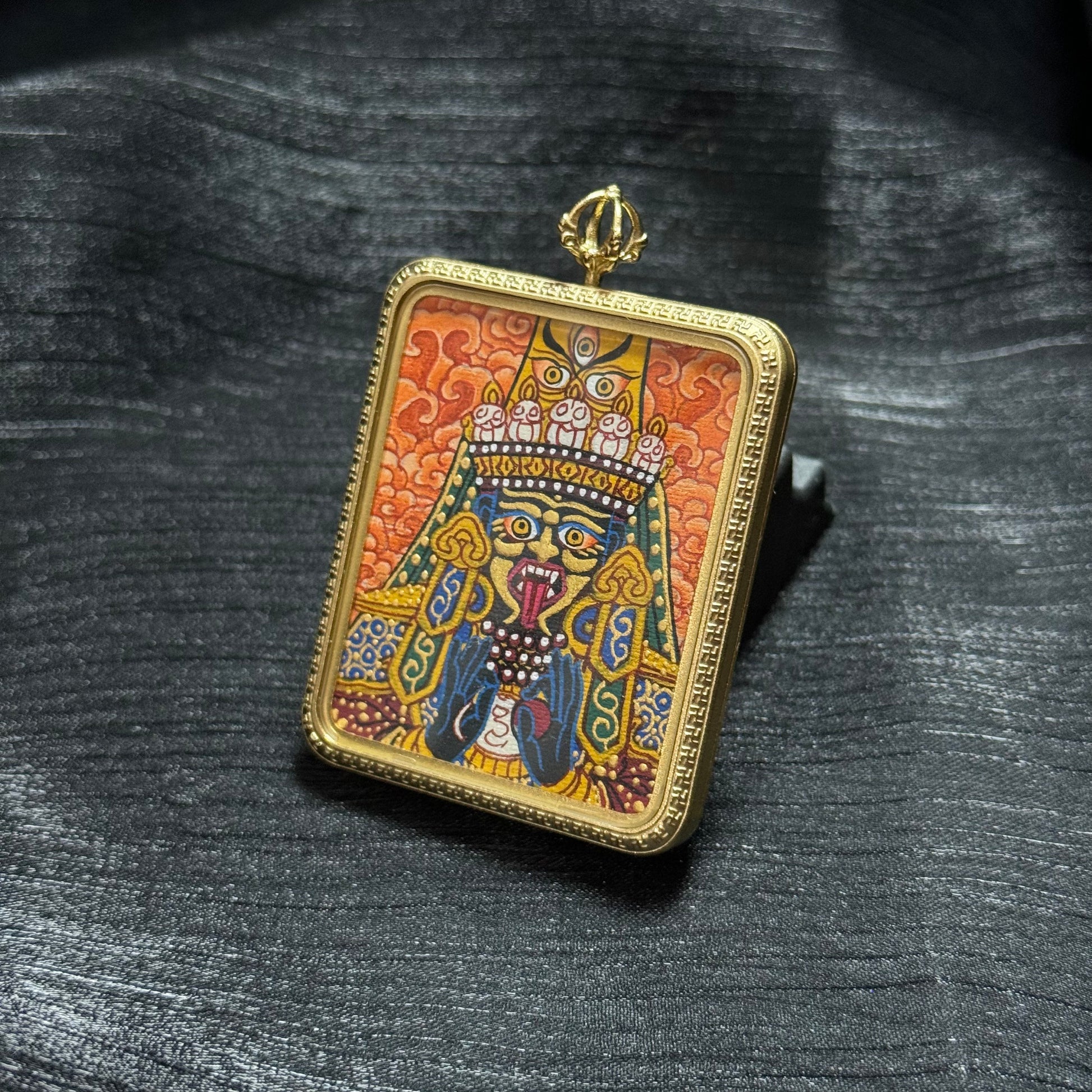 Angled view of Zaki Ram Buddhist goddess mini thangka pendant showing detailed mineral pigment painting and traditional Nepalese thangka style