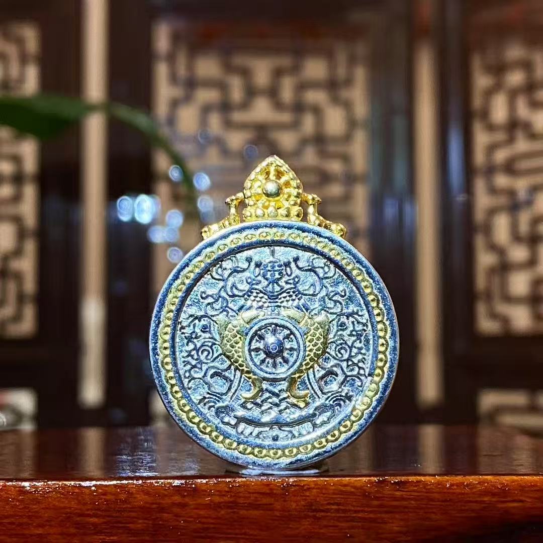 Back view of a Manjushri Bodhisattva mini thangka pendant featuring a Dharma Wheel design on a 925 sterling silver Gau box