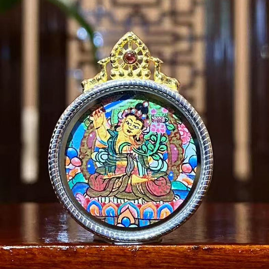 Hand-painted Manjushri Bodhisattva mini thangka pendant in a 925 sterling silver circular Gau box, depicting the Buddhist deity of wisdom