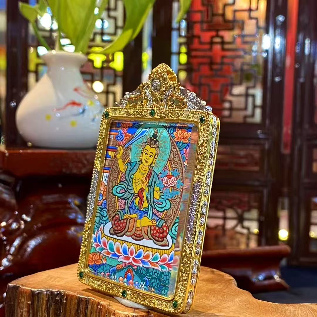 Side view of a Manjushri Bodhisattva mini thangka pendant highlighting the ornate gold-plated copper Gau box frame