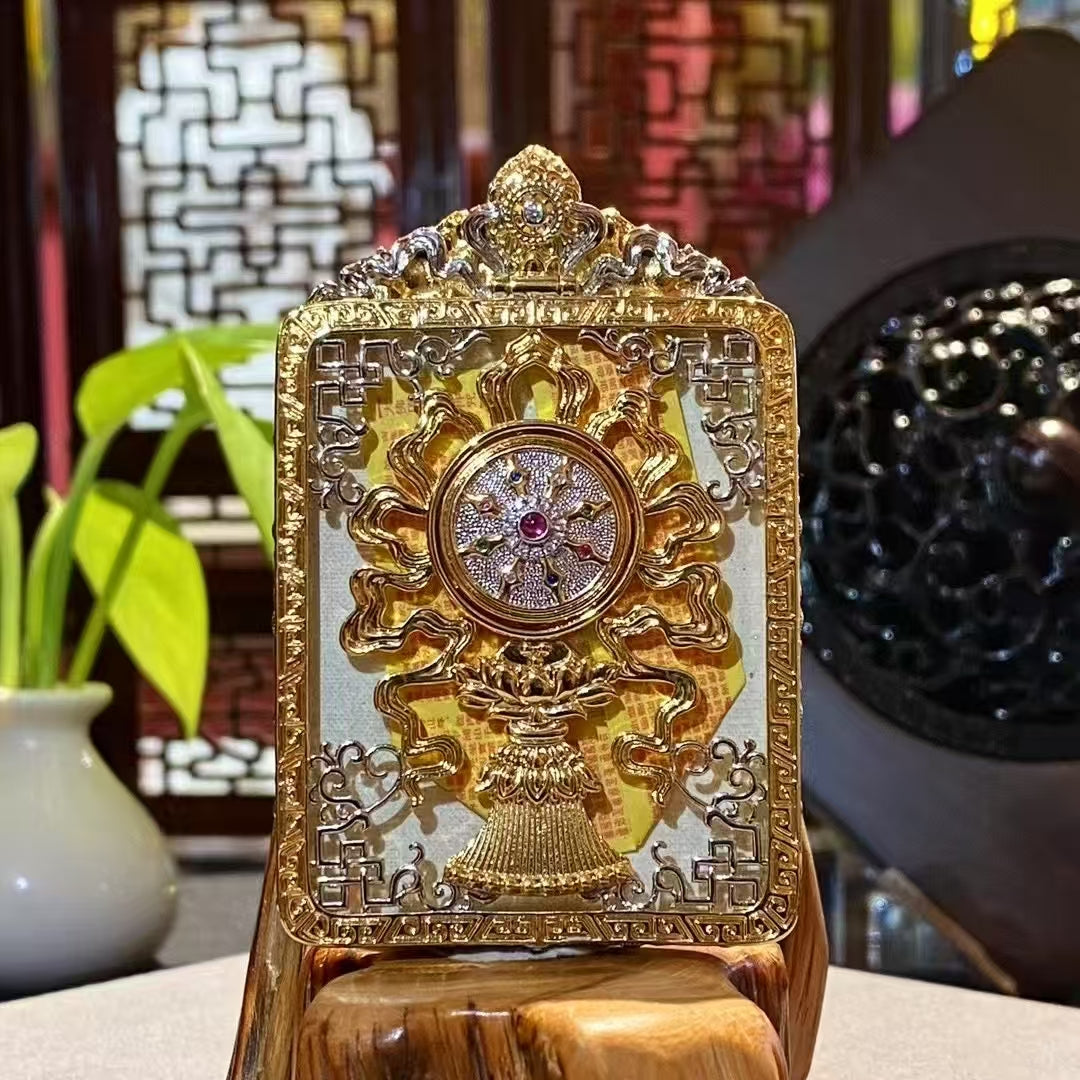 Back view of a Manjushri Bodhisattva mini thangka pendant featuring an embossed Wisdom Wheel on a gold-plated copper Gau box