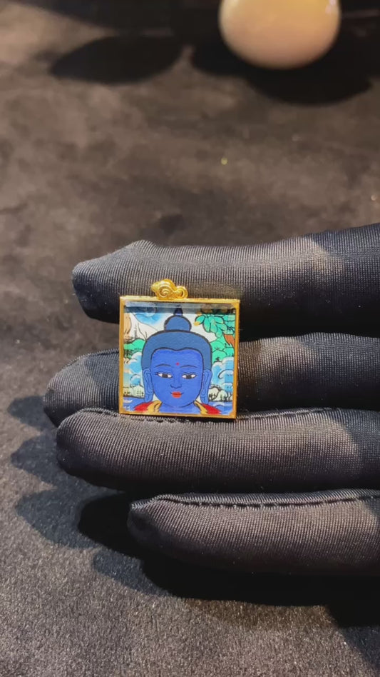360-degree view of Medicine Buddha Tibetan mini thangka pendant, double-sided hand-painted in 18K gold, set in a sapphire crystal gau box
