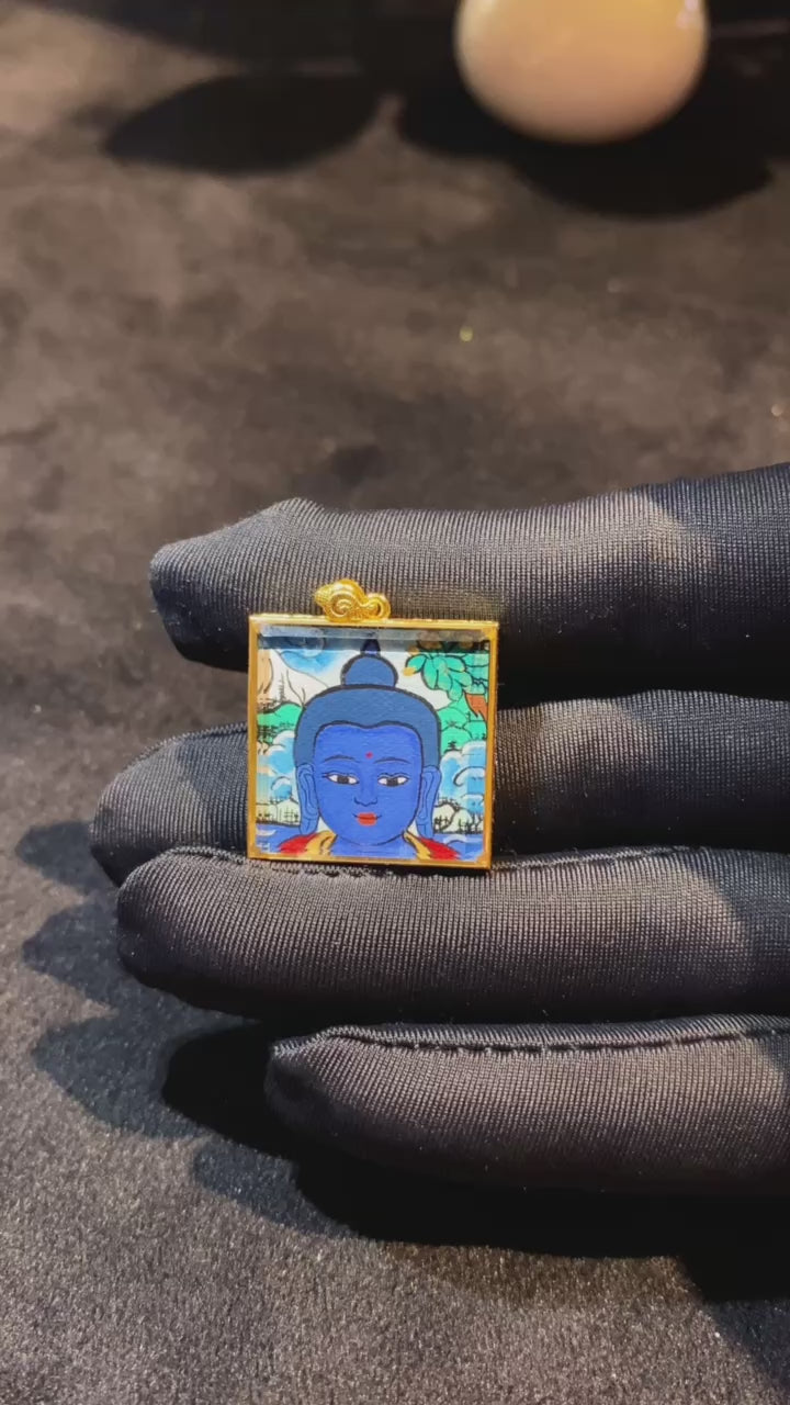 360-degree view of Medicine Buddha Tibetan mini thangka pendant, double-sided hand-painted in 18K gold, set in a sapphire crystal gau box