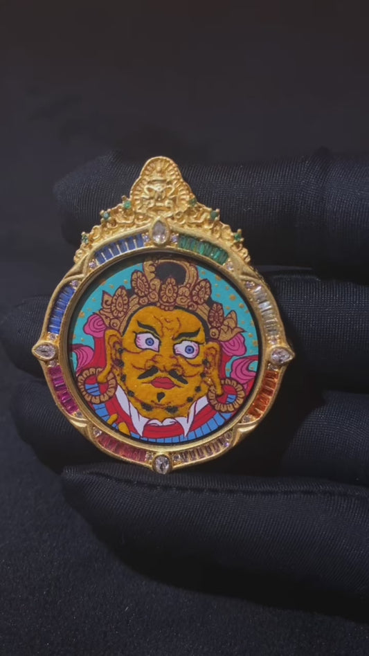 video of hand-painted Yellow Jambhala Thangka set in an ornate rainbow Tibetan Gawu pendant with gemstone details