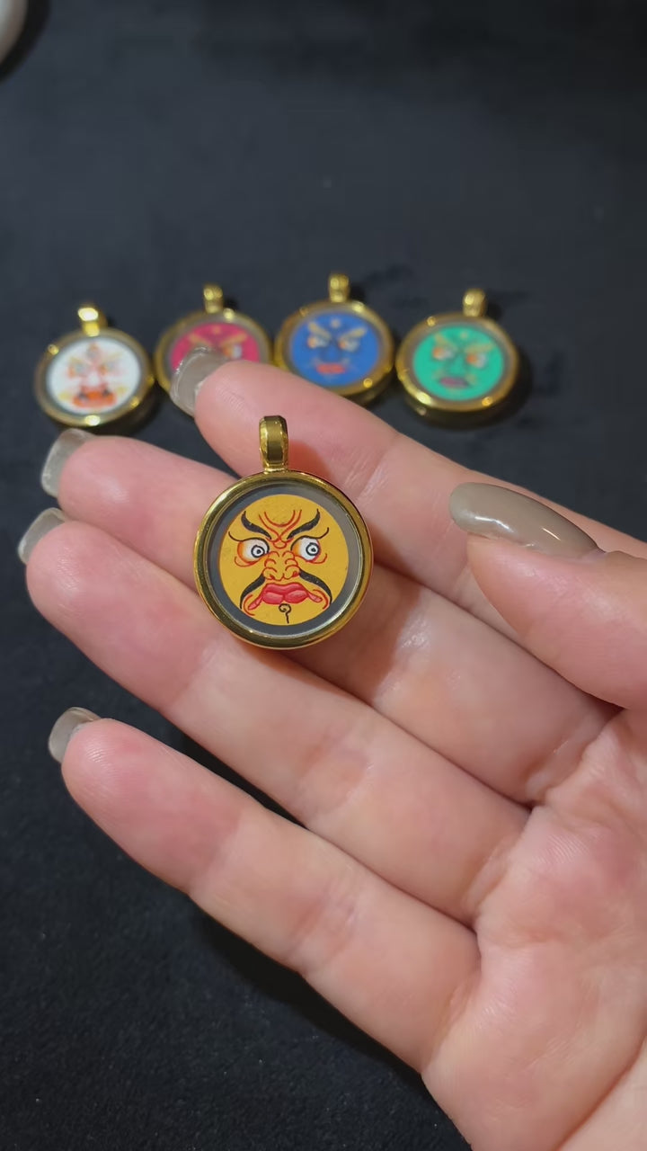 Short video showcasing a hand-painted Yellow Jambhala Thangka Gawu pendant in titanium steel, highlighting craftsmanship, consecrated contents, and compact design for daily wear