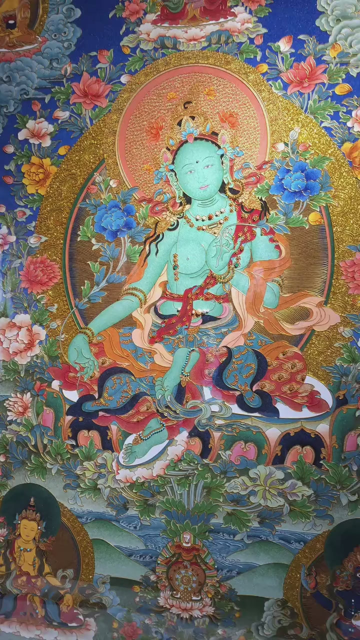 Video showing a 100% hand-painted Green Tara Tibetan Thangka created in the Rebgong gemstone tradition, featuring mineral pigments, detailed craftsmanship, and pear wood framing