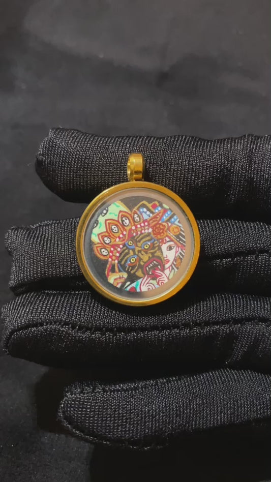 Video showcasing a hand-painted Zaki Lhamo thangka pendant in a titanium steel gau box, highlighting front, side, back details and gold-painted craftsmanship
