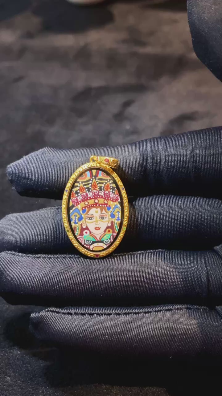 Video showcasing a double-sided Tibetan Ghau Thangka pendant with Zaki Lham and Avalokiteshvara (Guanyin), hand-painted in 18K gold using Rebgong Thangka craftsmanship with sapphire glass protection