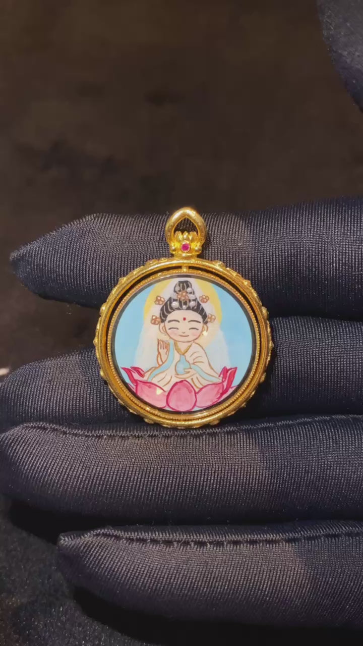 Video showcasing a double-sided 18K gold hand-painted Thangka pendant featuring Q-style Guanyin on the front and Fox Spirit imagery on the back, crafted in the Rebgong tradition with a reversible Gau box design