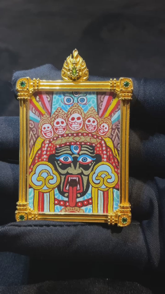 Close-up video of a large Zaki Lhamo double-sided Tibetan Thangka pendant, fully hand-painted in 18K gold in the Rebgong tradition, featuring a sapphire crystal Gawu box and the “Daily Growing Wealth” design on the back