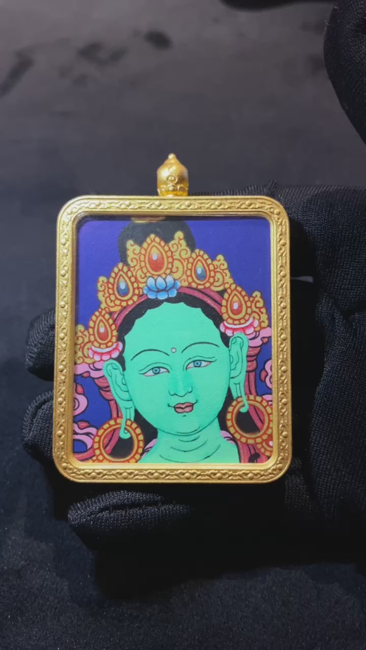 Short video showcasing a hand-painted Green Tara Gau Thangka pendant with a gold-plated copper case and Garuda back, highlighting front, side, and back details