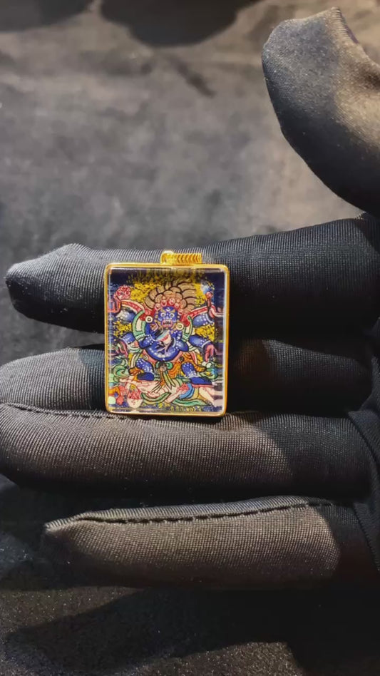 Six-Armed Mahakala Gau pendant, hand-painted with 18K gold in the Rebgong Tibetan tradition. Features Kapala and Vajra chopper symbolism, sapphire crystal cover, size 21 × 26 mm.
