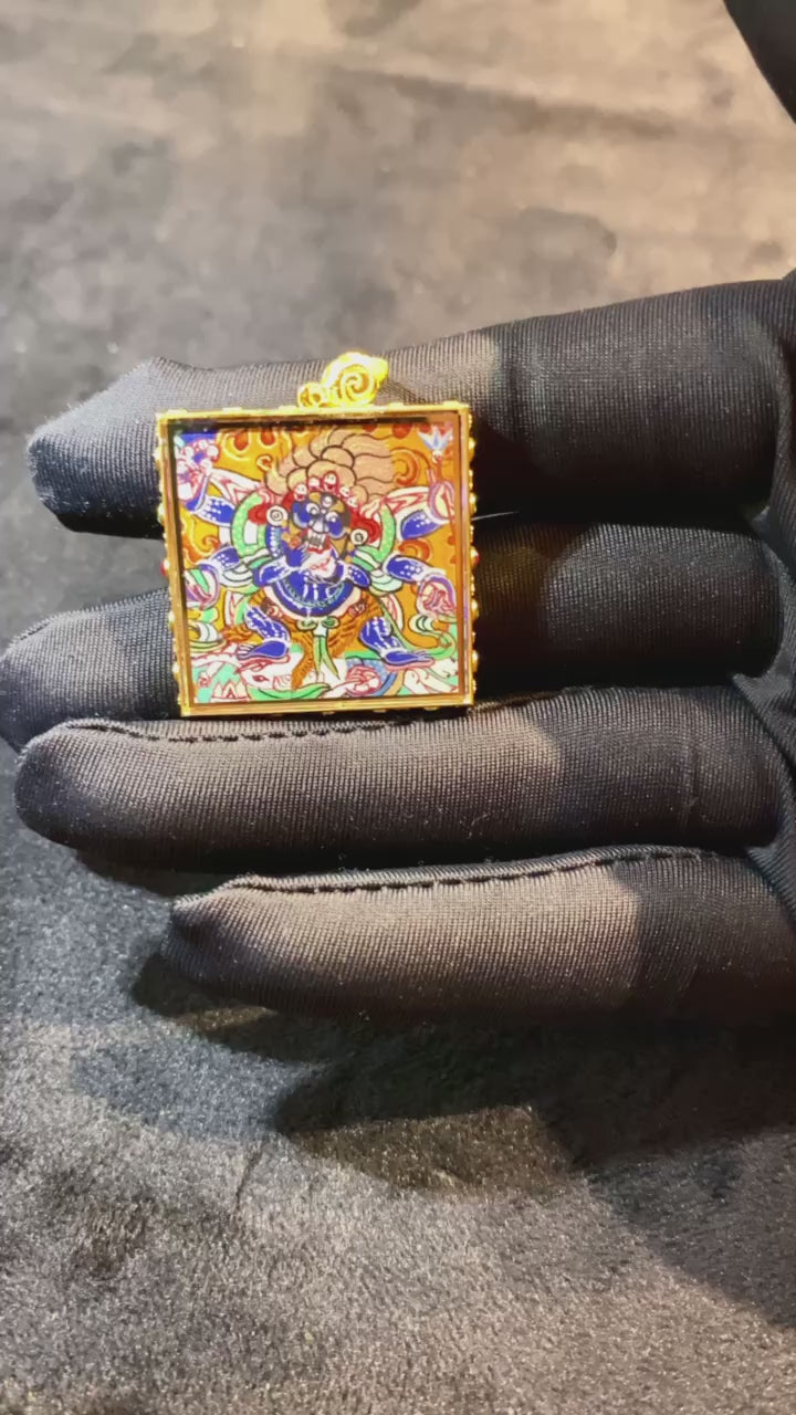 Authentic Six-Armed Mahakala Gau pendant, dual-sided and fully hand-painted with 18K gold in the Rebgong Tibetan tradition. Features Kapala and Vajra chopper symbolism, sapphire crystal cover, 26 mm.
