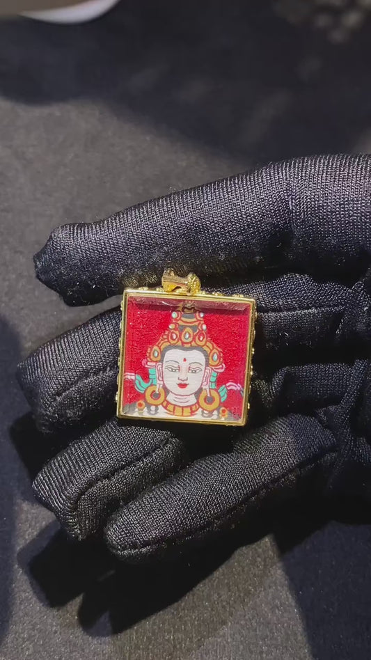 Video showcasing a hand-painted Green Tara mini thangka pendant, featuring the copper Ghau box, sacred mantra, seven-treasure beads and khata
