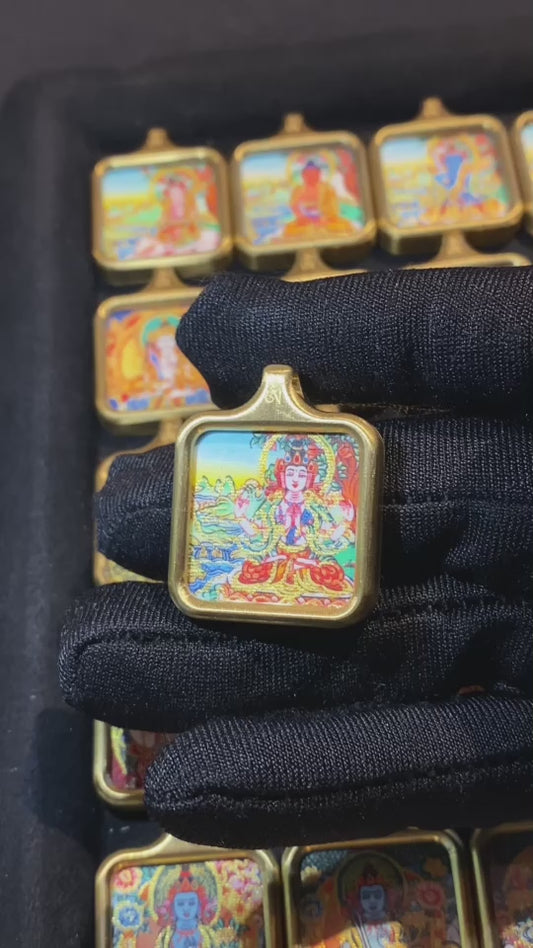 Video showcasing hand-painted gold-outlined Tibetan thangka pendants in square 24×24mm titanium steel gau boxes for wholesale orders