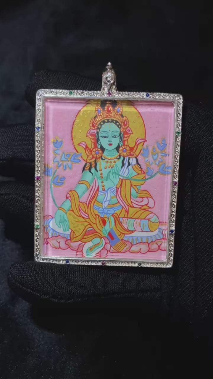 Video showcasing a hand-painted large Gau Thangka pendant with Green Tara on the front and sacred scriptures on the back, crafted in a traditional copper case