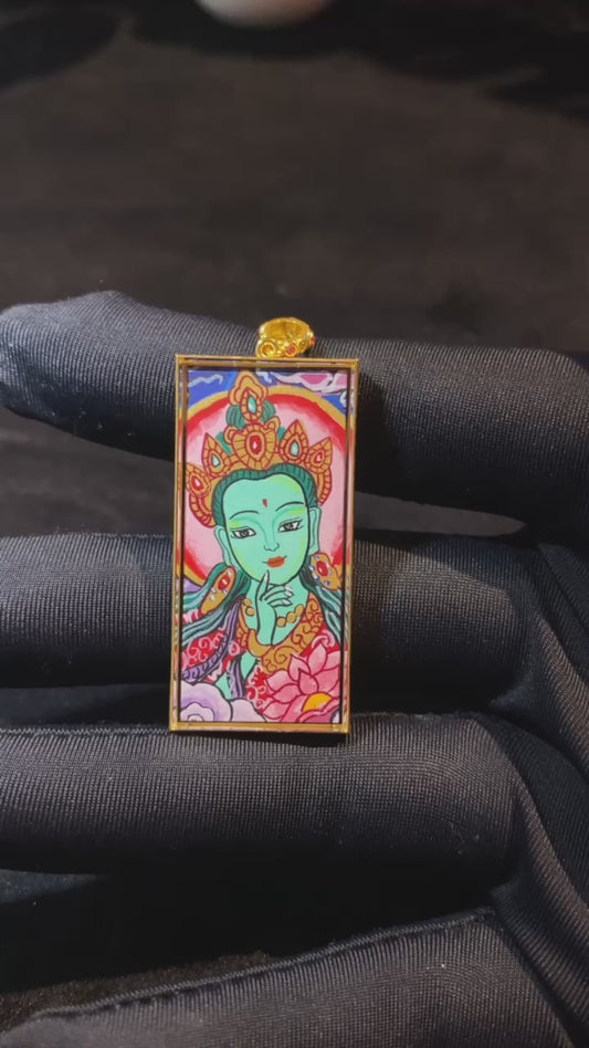 Product video showcasing a double-sided Green Tara and Om Mani Padme Hum Thangka pendant, fully hand-painted with 18K gold in Rebgong tradition and set in a sapphire crystal Gau box.

