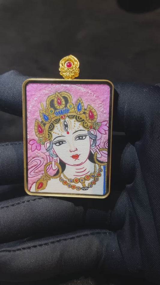Video showcasing a double-sided Tibetan Ghau Thangka pendant with Zaki Lham and White Tara, hand-painted in 18K gold with Rebgong Thangka craftsmanship and sapphire glass protection