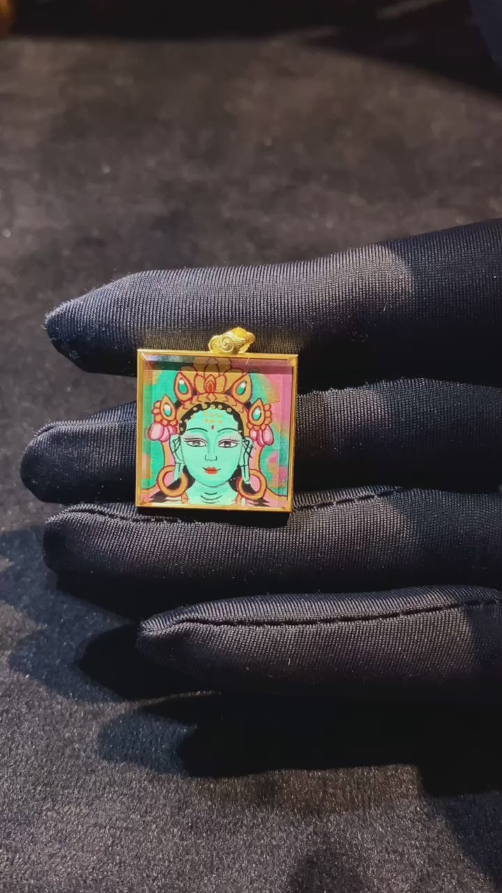 Video showcasing a double-sided hand-painted Green Tara and Utpala Flower thangka pendant in an 18K gold Ghau box with sapphire crystal glass