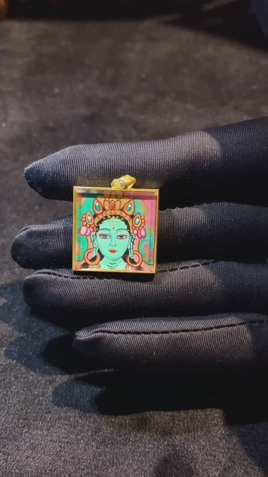 Video showcasing a double-sided hand-painted Green Tara and Utpala Flower thangka pendant in an 18K gold Ghau box with sapphire crystal glass