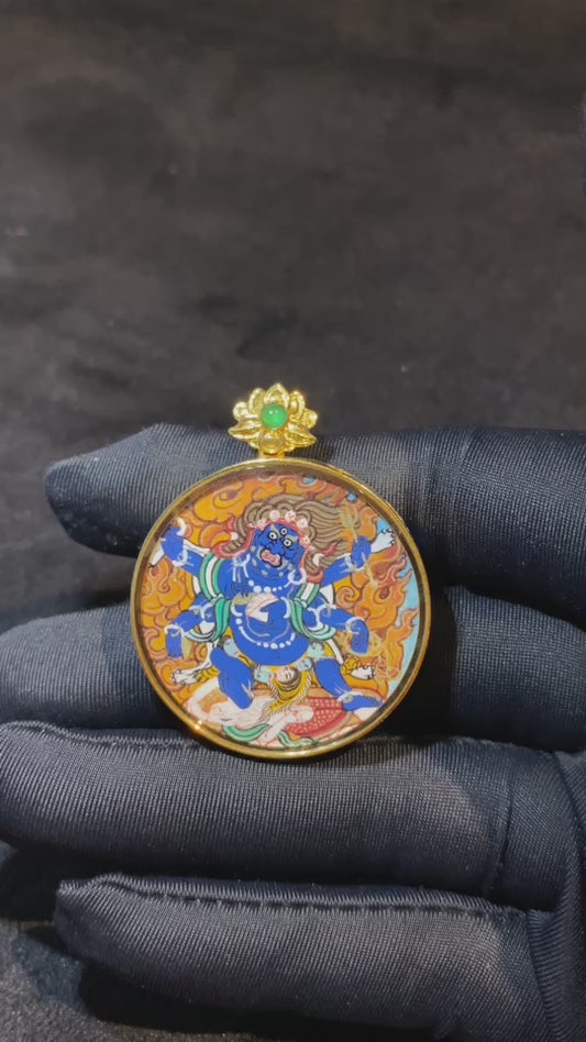 Authentic Six-Armed Mahakala Gau pendant, fully hand-painted with 18K gold in the Rebgong Tibetan tradition. Dual-sided artwork with sapphire crystal cover, diameter 31 mm.
