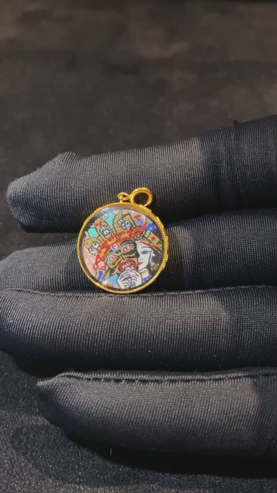 Video showcasing a round Tibetan Ghau Thangka pendant with Zaki Lham, hand-painted in 18K gold using Rebgong Thangka techniques, featuring sapphire glass and compact 17mm design