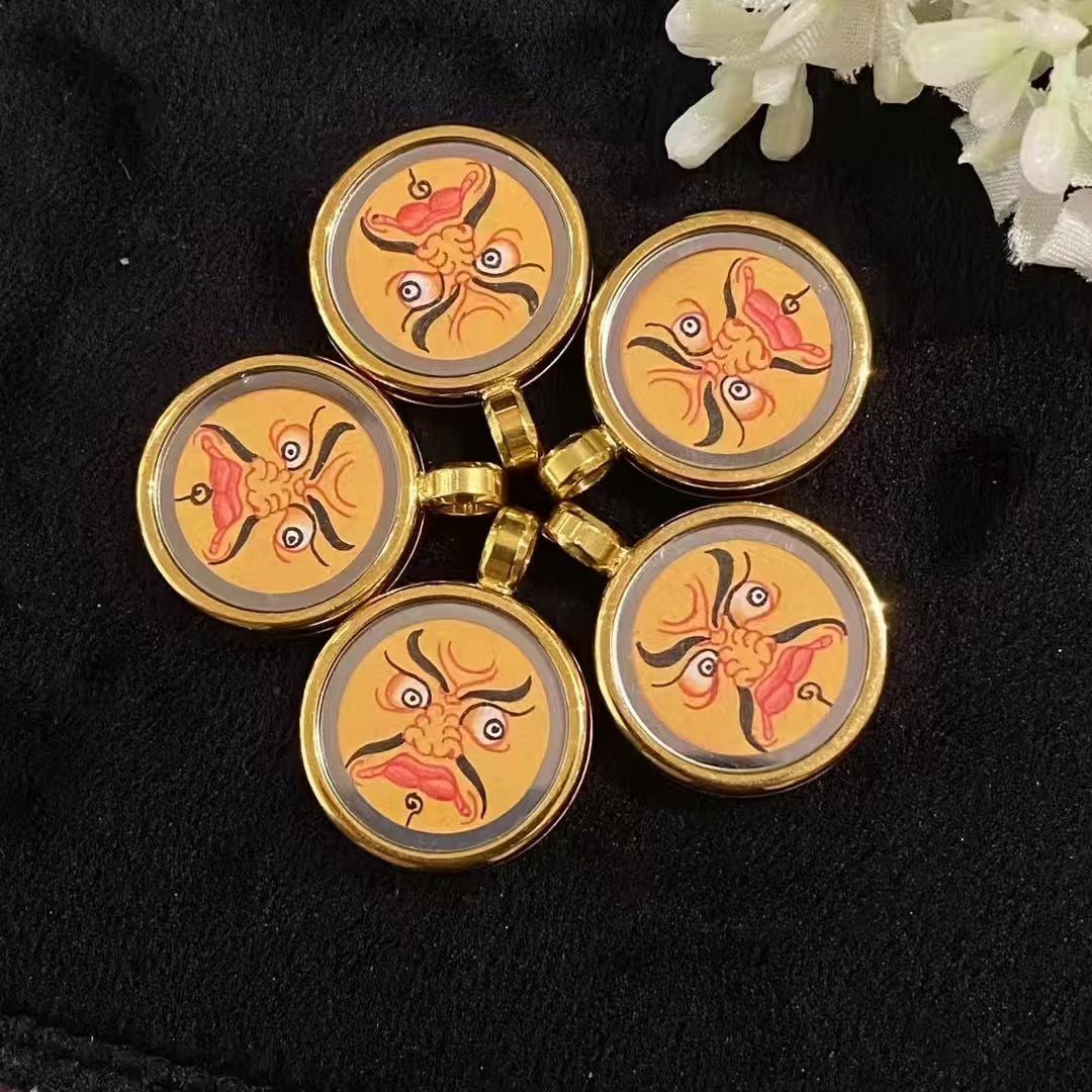 Hand-painted Yellow Jambhala Thangka set in a titanium steel Tibetan Gawu pendant, compact wealth deity amulet